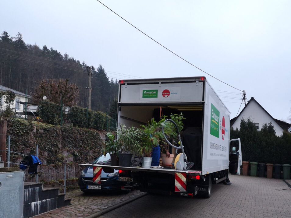 Umzugs-LKW mit heruntergefahrener Ladeklappe, auf der unsere Pflanzen stehen