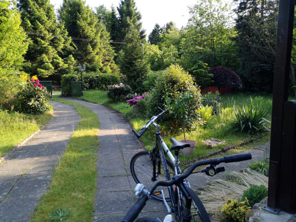 Foto unseres Gartens mit zwei Fahrrädern vor dem Haus